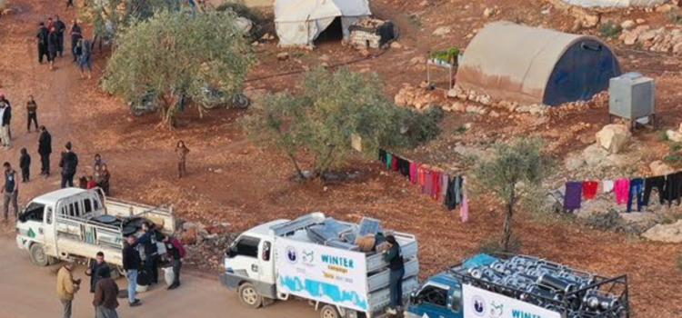 Trucks delivering aid to a refugee camp