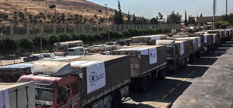 OCHA/David Swanson Trucks carrying food assistance cross the Turkish border into Syria. (file photo)